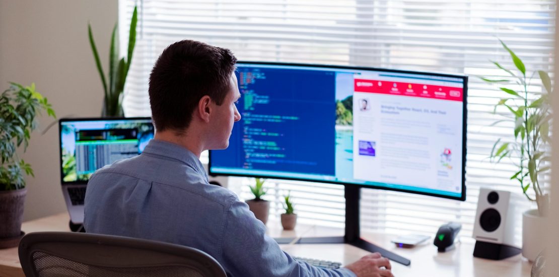 Expert ERP Solution: man in gray dress shirt sitting on chair in front of computer monitor