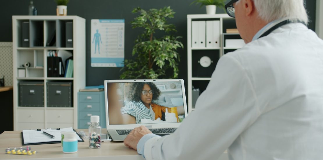 Doctor consults with patient via video call.