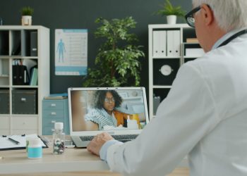 Doctor consults with patient via video call.